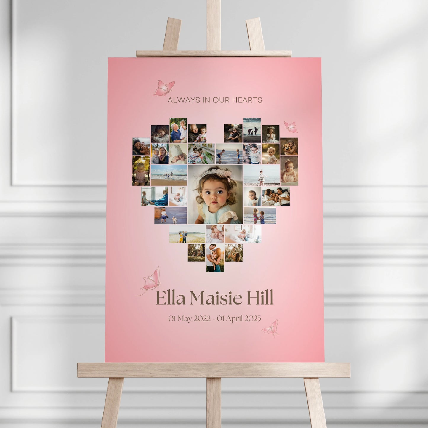 Heart-shaped photo collage memorial sign on a pink background, featuring a collection of cherished photos arranged in a heart shape. Personalised with the name "Ella Maisie Hill," dates, and delicate butterfly accents, creating a beautiful tribute for remembrance and celebration of life.