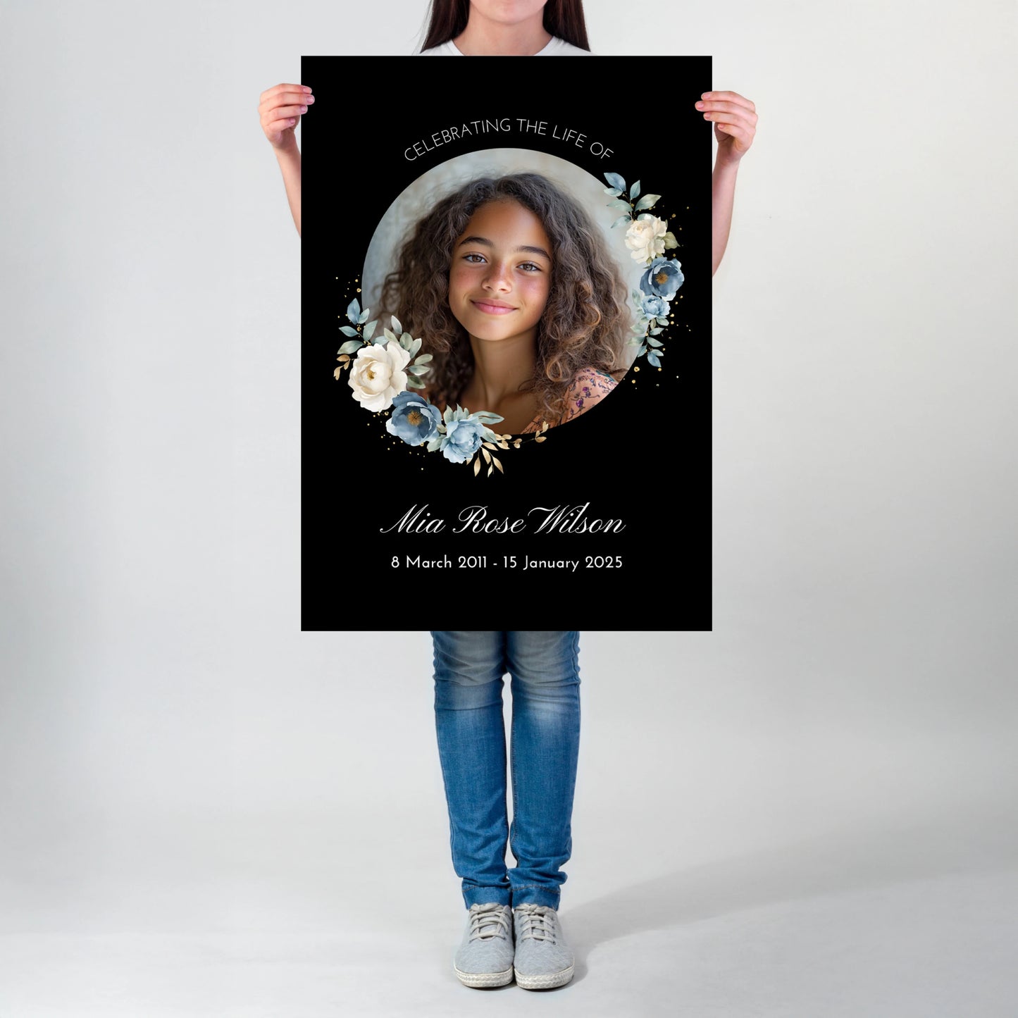 Personalized memorial welcome sign featuring a custom photo of a girl set in a circle, adorned with blue and white roses on a black background, honouring the life of Mia Rose Wilson with her date at the bottom.