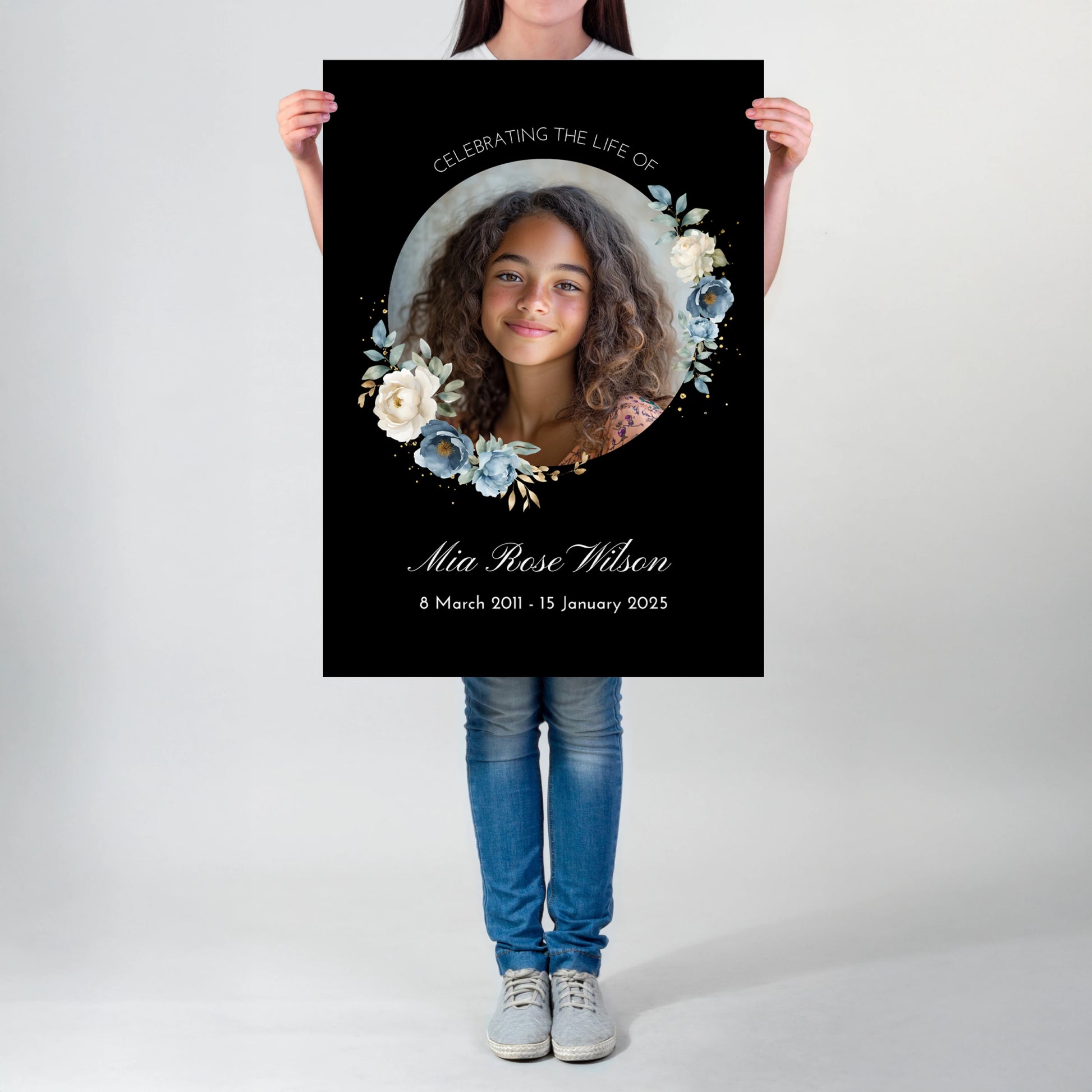 Personalized memorial welcome sign featuring a custom photo of a girl set in a circle, adorned with blue and white roses on a black background, honouring the life of Mia Rose Wilson with her date at the bottom.