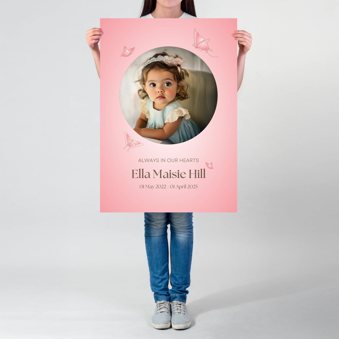 Memorial sign with a soft pink background, featuring a cherished photo, delicate butterfly accents, and personalised with the name "Ella Maisie Hill" and her dates. A beautiful tribute for remembrance and celebration of life.