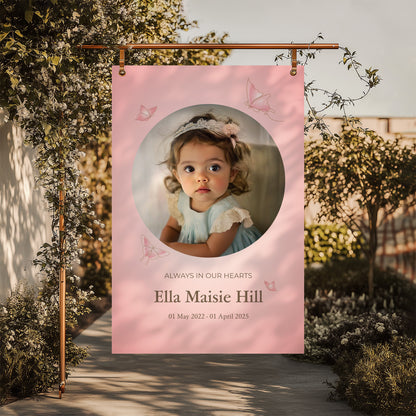 Memorial sign with a soft pink background, featuring a cherished photo, delicate butterfly accents, and personalised with the name "Ella Maisie Hill" and her dates. A beautiful tribute for remembrance and celebration of life.