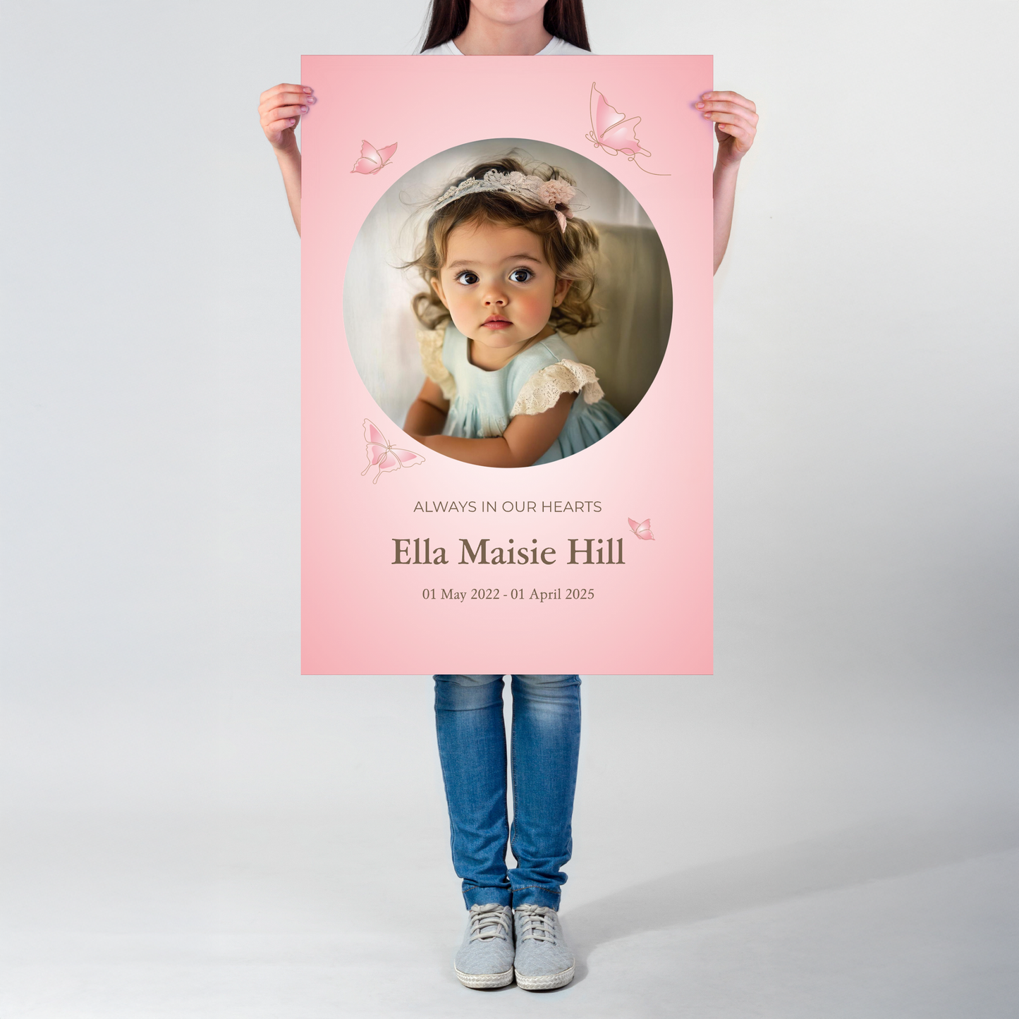 Memorial sign with a soft pink background, featuring a cherished photo, delicate butterfly accents, and personalised with the name "Ella Maisie Hill" and her dates. A beautiful tribute for remembrance and celebration of life.