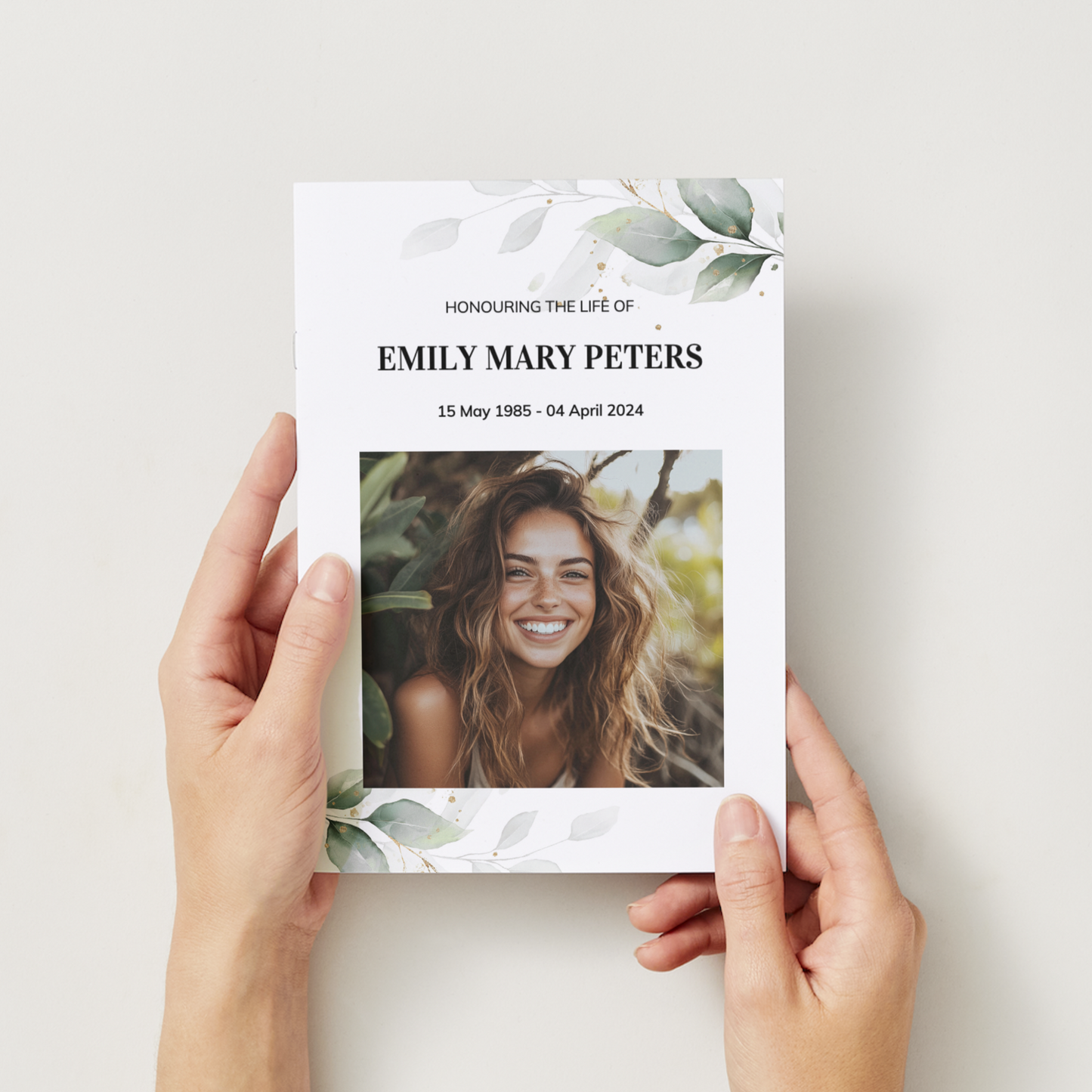 Elegant funeral order of service, single-fold memorial brochure with eucalyptus and photograph.